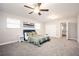 Spacious bedroom featuring a ceiling fan, large windows and a queen sized bed at 1887 King Charles Sw Rd, Atlanta, GA 30331