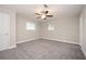 Spacious carpeted bedroom with ample light, windows, and a ceiling fan at 1887 King Charles Sw Rd, Atlanta, GA 30331