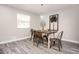 This dining room features tile floors, a modern light fixture, and a wood table with metal chairs at 1887 King Charles Sw Rd, Atlanta, GA 30331