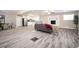 Open-concept living area with wood-look flooring, fireplace, and seamless transition to the kitchen at 1887 King Charles Sw Rd, Atlanta, GA 30331