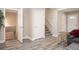 The living room shows access to the unfinished basement as well as the stairwell to the upper level at 1887 King Charles Sw Rd, Atlanta, GA 30331