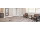 Inviting living room with wood-look floors, neutral paint, and natural light from multiple windows at 1887 King Charles Sw Rd, Atlanta, GA 30331