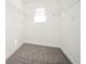 A walk-in closet features carpet flooring, wire shelving and a window at 1887 King Charles Sw Rd, Atlanta, GA 30331