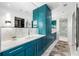 Elegant bathroom with blue cabinets, marble countertops, dual sinks, and a glass-enclosed shower at 845 Spring Nw St # 502, Atlanta, GA 30308