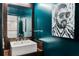 Stylish bathroom with a vessel sink, bold teal walls, and modern wood-grain accents at 845 Spring Nw St # 502, Atlanta, GA 30308