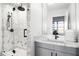 Bathroom features marble shower with matte black fixtures, sleek vanity, and large window at 845 Spring Nw St # 502, Atlanta, GA 30308