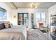 Bright bedroom with a comfortable bed, stylish decor, glossy floors, and access to a balcony with city views at 845 Spring Nw St # 502, Atlanta, GA 30308