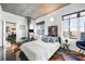 Bright bedroom featuring floor-to-ceiling windows, modern décor, and sleek concrete ceiling at 845 Spring Nw St # 502, Atlanta, GA 30308