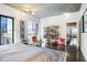 Bright bedroom featuring an inviting decor, glossy floors, and access to a balcony with city views at 845 Spring Nw St # 502, Atlanta, GA 30308