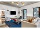 Bright living room with modern furnishings, including a large flat-screen TV and access to a balcony at 845 Spring Nw St # 502, Atlanta, GA 30308