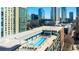 Rooftop pool deck with clear blue pool, lounge chairs, and city skyline views at 845 Spring Nw St # 502, Atlanta, GA 30308