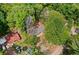 Aerial view of house nestled among lush trees with a charming neighboring property nearby at 160 Vandiver Rd, Canton, GA 30114
