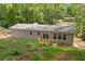 Aerial view of the house backyard showcasing the expansive space with a small wooden porch and green surroundings at 160 Vandiver Rd, Canton, GA 30114