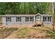 Charming home with gray siding, black shutters and a well-manicured lawn, perfect for suburban living at 160 Vandiver Rd, Canton, GA 30114