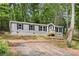 Inviting home with a well-maintained lawn and charming wood porch, perfect for relaxed outdoor enjoyment at 160 Vandiver Rd, Canton, GA 30114