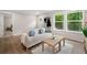 Bright living room featuring a comfortable couch, stylish decor, and natural light from large windows at 160 Vandiver Rd, Canton, GA 30114