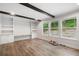 Cozy living room with built-in shelving, wood beams, and three large windows at 160 Vandiver Rd, Canton, GA 30114