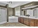 Bathroom features a garden tub, shower, and double vanity with wood cabinets at 1384 Stone Bay Sw Dr, Atlanta, GA 30331