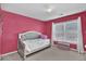 Stylish bedroom featuring a modern upholstered bed, a window, and a cushioned ottoman at 1384 Stone Bay Sw Dr, Atlanta, GA 30331