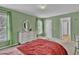Bright bedroom featuring an oversized window and a white dresser with decorative mirror at 1384 Stone Bay Sw Dr, Atlanta, GA 30331