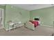 Cozy bedroom featuring green walls, a vintage bed, and a quaint writing desk at 1384 Stone Bay Sw Dr, Atlanta, GA 30331