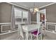 Elegant dining room with white furniture, large window, chandelier, and view into the kitchen at 1384 Stone Bay Sw Dr, Atlanta, GA 30331