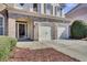 Close-up of a home's entrance featuring a two-car garage, brick accents, and a well-manicured front yard at 1384 Stone Bay Sw Dr, Atlanta, GA 30331