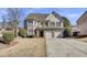 Charming two-story home featuring brick and stucco exterior, well-maintained lawn, and a two-car garage at 1384 Stone Bay Sw Dr, Atlanta, GA 30331