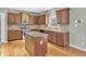 Well-lit kitchen with wood cabinets, stainless steel appliances, island, and hardwood floors at 1384 Stone Bay Sw Dr, Atlanta, GA 30331