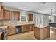 Well-equipped kitchen featuring stainless steel appliances, wooden cabinets, and access to living area at 1384 Stone Bay Sw Dr, Atlanta, GA 30331
