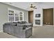 Comfortable living room features a fireplace, ceiling fan, and a large window at 1384 Stone Bay Sw Dr, Atlanta, GA 30331