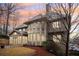 Beautiful view of the home exterior highlighting the ample windows and wooded backyard at 1884 Point River Dr, Duluth, GA 30097