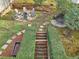 Elevated view of backyard featuring a fire pit, egg chair, and stone stairs with manicured hedges at 1884 Point River Dr, Duluth, GA 30097