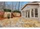 Outdoor patio with stone, wood retaining wall, trees, and sliding glass doors at 1884 Point River Dr, Duluth, GA 30097