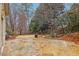 Backyard features a stone patio, lush landscaping, and a serene koi pond at 1884 Point River Dr, Duluth, GA 30097