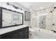 This is a sleek bathroom with marble countertops, a framed mirror, updated fixtures, and a glass shower at 1884 Point River Dr, Duluth, GA 30097
