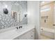 Stylish bathroom features quartz counters, decorative tile accent wall and modern fixtures at 1884 Point River Dr, Duluth, GA 30097