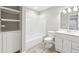 Bright bathroom with neutral paint, vanity with storage and combo shower-tub at 1884 Point River Dr, Duluth, GA 30097