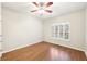 A bedroom is well-lit by a window and has hardwood floors at 1884 Point River Dr, Duluth, GA 30097