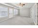 Spacious bedroom with carpet, tray ceiling with ceiling fan, and double doors at 1884 Point River Dr, Duluth, GA 30097