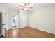 This bedroom boasts hardwood floors, ceiling fan, neutral paint and an attached bathroom at 1884 Point River Dr, Duluth, GA 30097