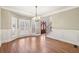 Dining room with hardwood floors, wainscoting, and large windows offering natural light at 1884 Point River Dr, Duluth, GA 30097