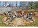 Backyard seating area with stone patio, fire pit, and Adirondack chairs at 1884 Point River Dr, Duluth, GA 30097