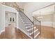 Bright foyer boasts hardwood floors, staircase with metal spindles, and entry to the dining room at 1884 Point River Dr, Duluth, GA 30097