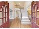 Grand foyer entrance with hardwood floors, staircase, and soaring ceilings at 1884 Point River Dr, Duluth, GA 30097
