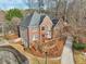 Brick home with landscaped yard featuring a circular driveway at 1884 Point River Dr, Duluth, GA 30097