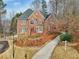 A view of a brick home with a neatly landscaped front yard and walkway at 1884 Point River Dr, Duluth, GA 30097