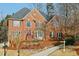 Traditional brick home with well-maintained landscaping and a welcoming entrance at 1884 Point River Dr, Duluth, GA 30097