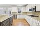 Bright kitchen featuring granite countertops, stainless steel appliances, and ample white cabinetry at 1884 Point River Dr, Duluth, GA 30097