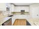 Kitchen with granite countertops, stainless steel appliances, white cabinets, and hardwood flooring at 1884 Point River Dr, Duluth, GA 30097